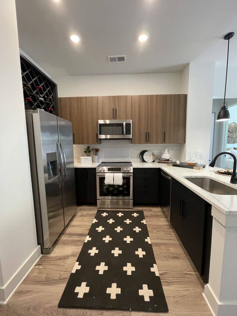 Model apartment kitchen at Margaux Midtown with stainless steel appliances and modern cabinetry