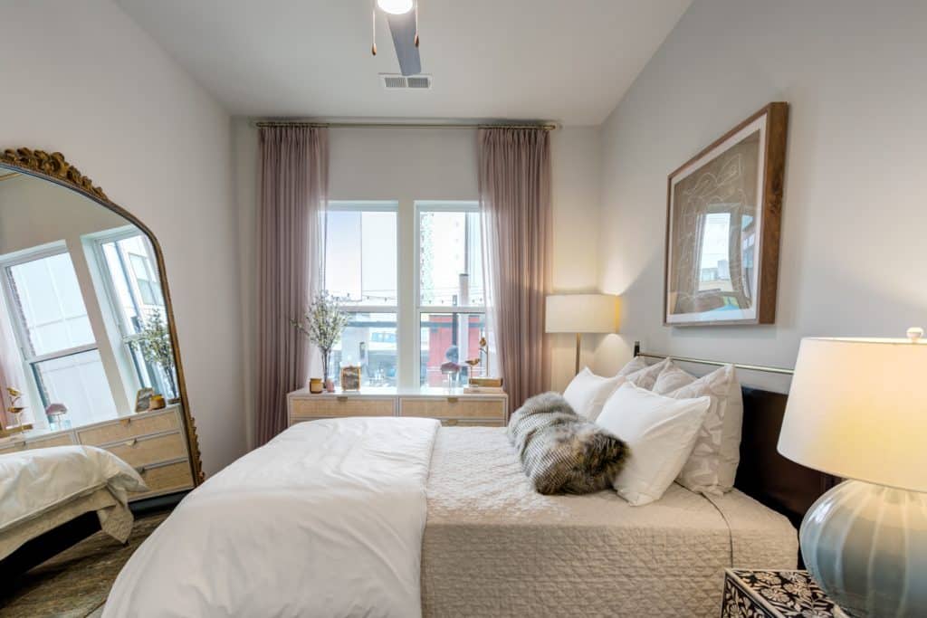 Modern furnished bedroom with large windows at Margaux Midtown