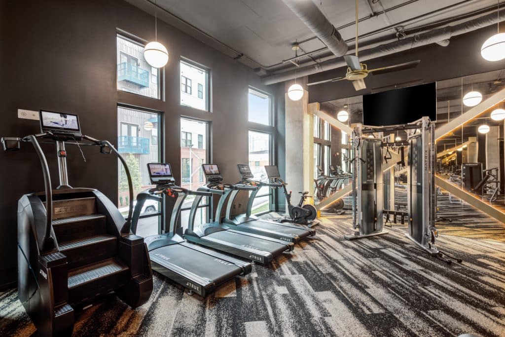 Stair stepper and treadmills available to residents in Margaux Midtown's fitness center