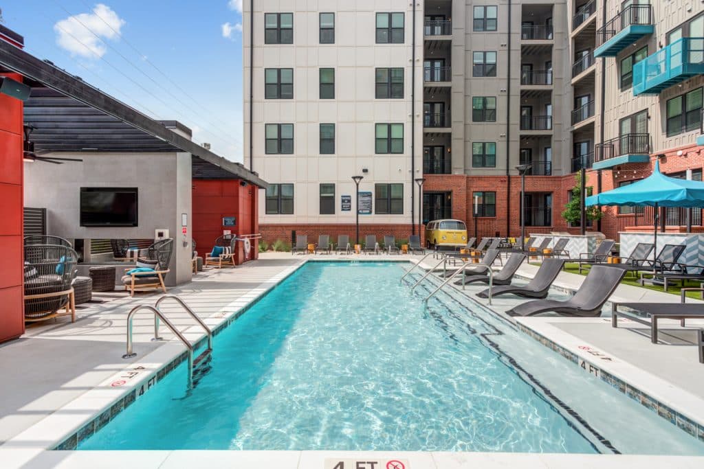 Large community pool at the Margaux Midtown with ample deck seating